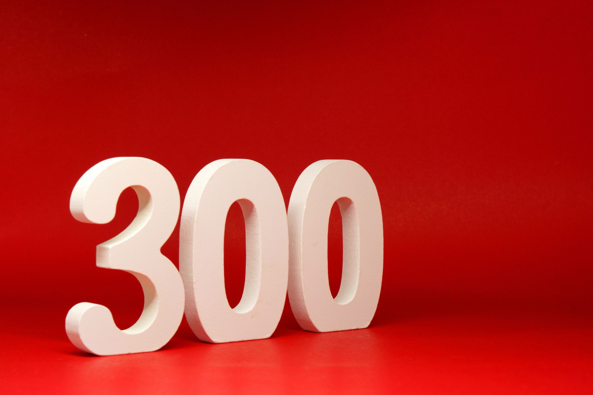 No 300 ( three hundred ) Isolated red  Background with Copy Space - Number 300% Percentage or Promotion - Discount or anniversary concept